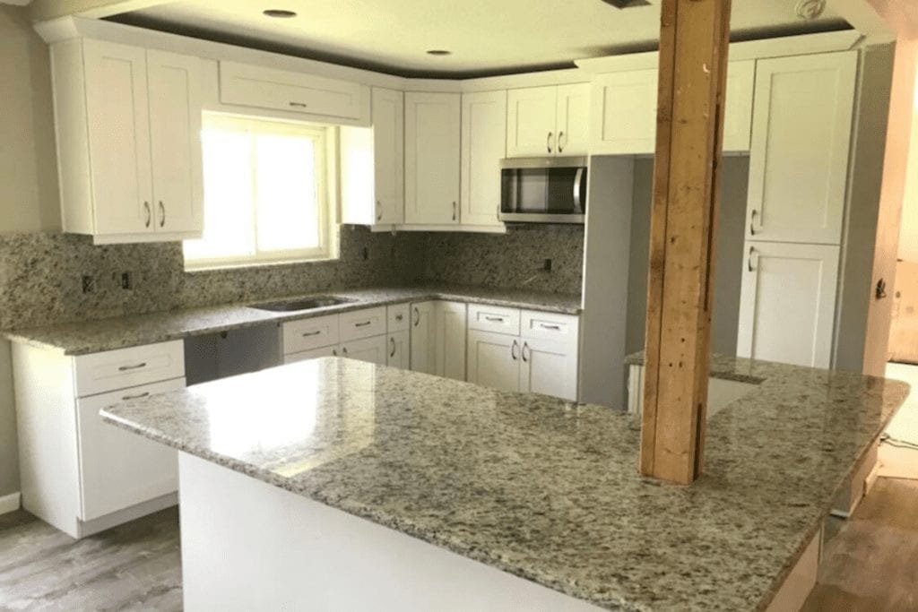 White kitchen with granite countertops by 1 Stop Cabinets