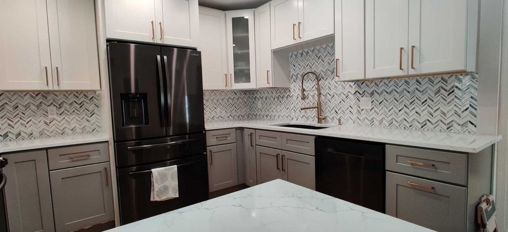 Two-tone white and gray shaker kitchen with quartz island rose gold hardware and chevron marble backsplash by 1 Stop Cabinets