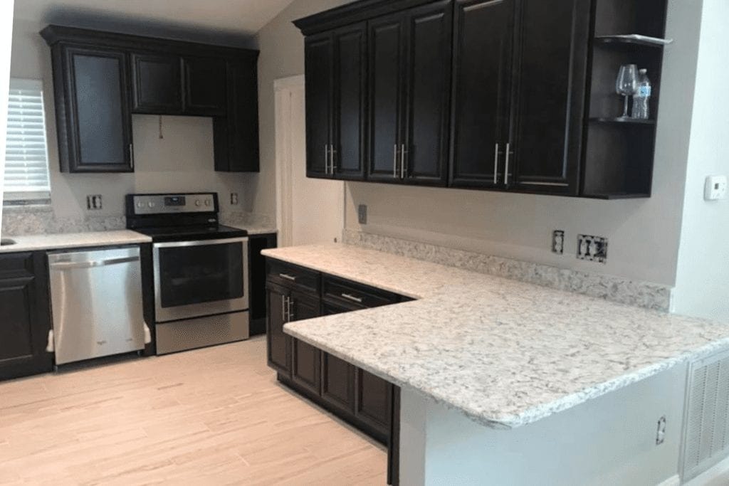 Dark espresso kitchen with granite countertops and stainless appliances by 1 Stop Cabinets