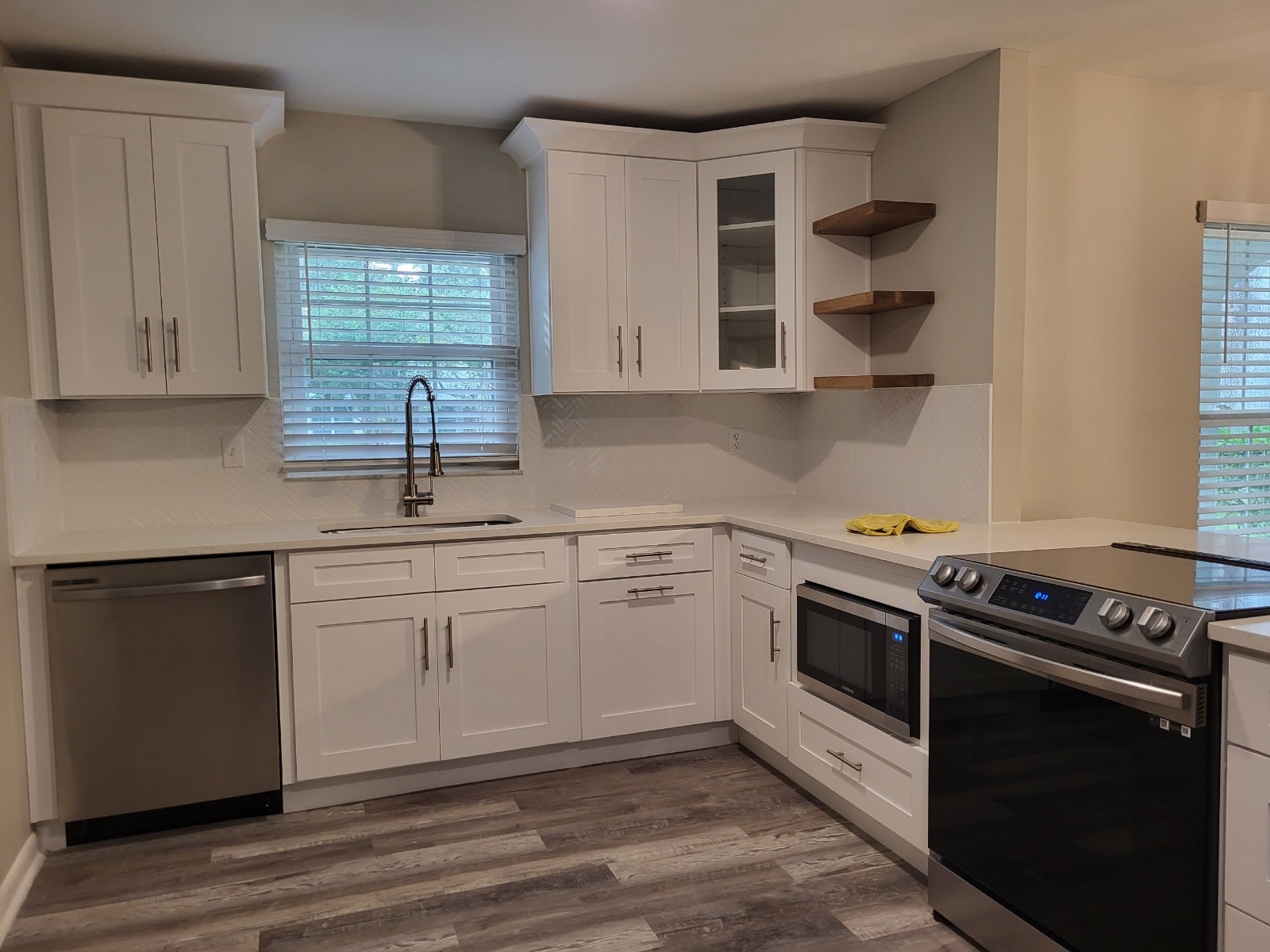 White raised panel kitchen under construction with crown molding and marble tile floors by 1 Stop Cabinets