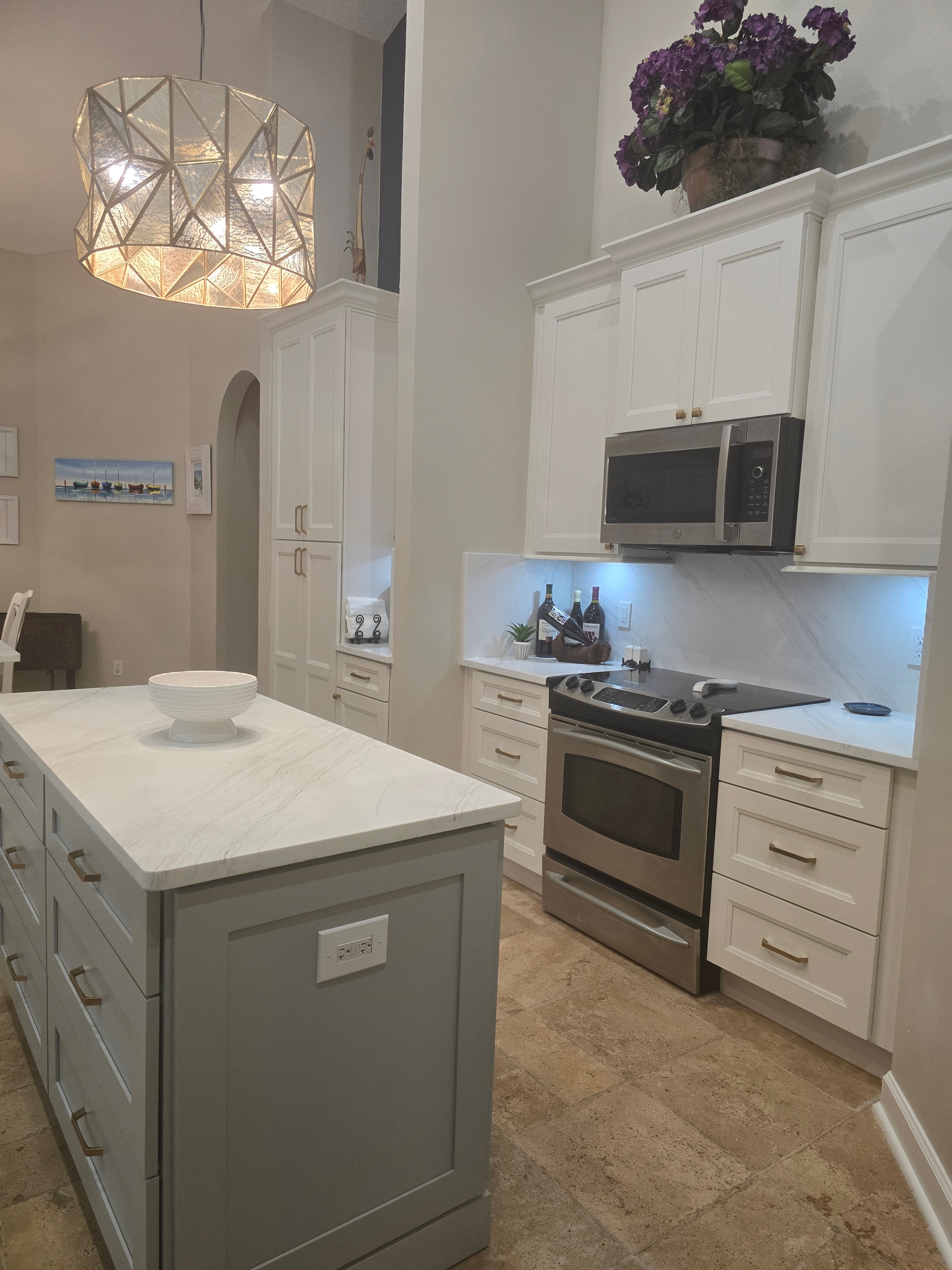 White raised panel kitchen with sage green island by 1 Stop Cabinets