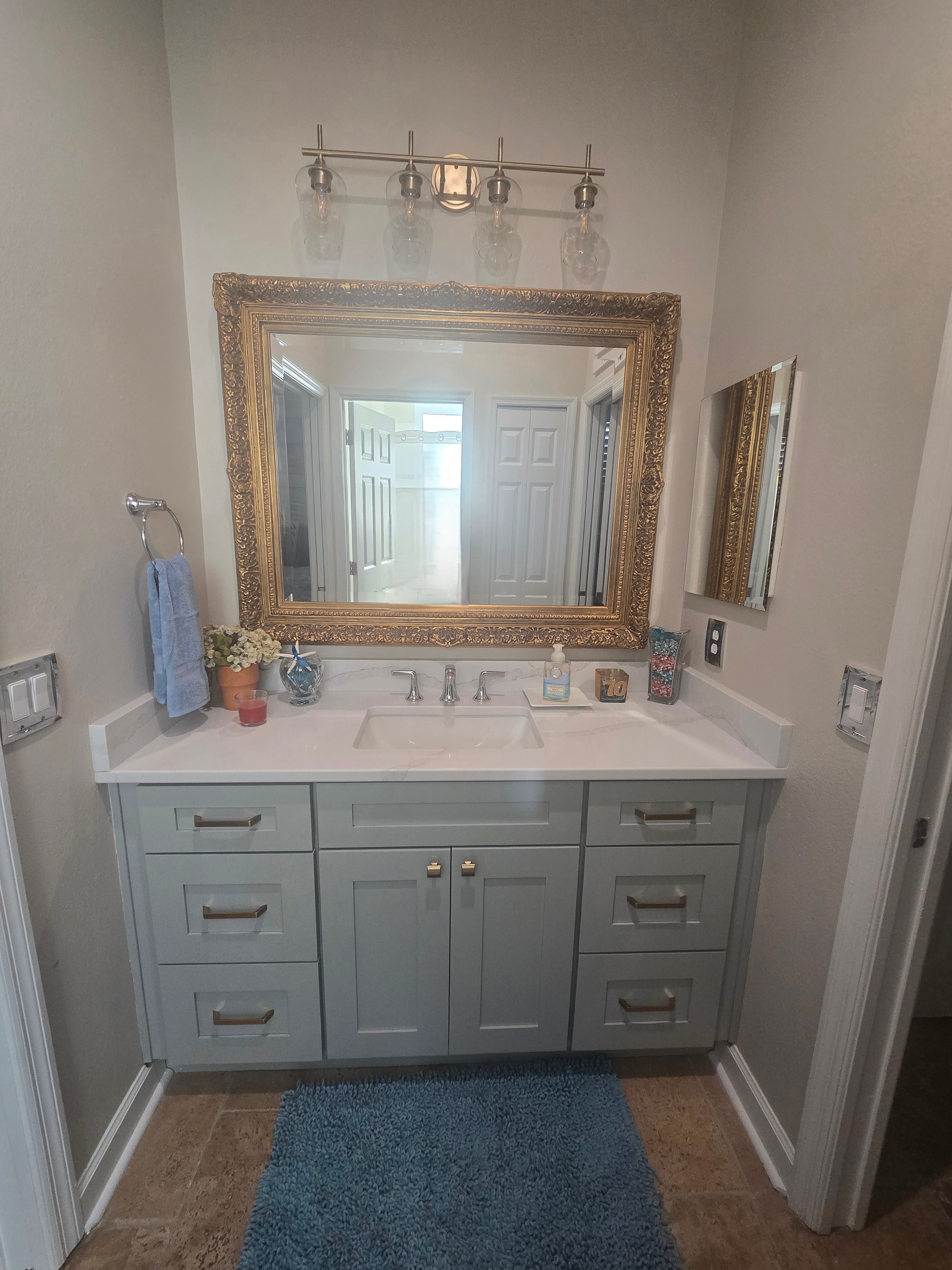 Sage green shaker bathroom vanity with gold mirror by 1 Stop Cabinets