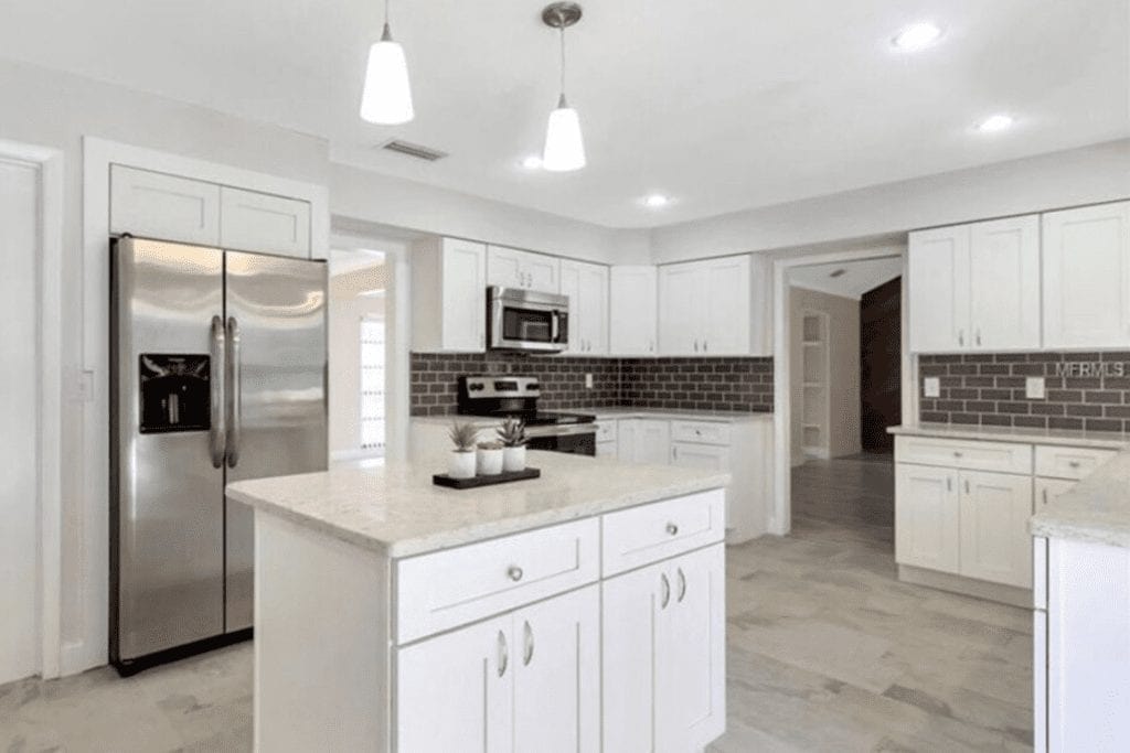 White shaker kitchen with granite countertops by 1 Stop Cabinets