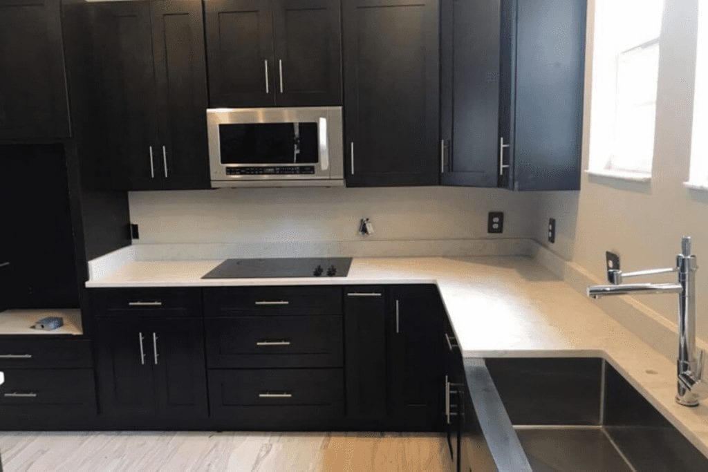 Dark shaker kitchen with white countertops by 1 Stop Cabinets