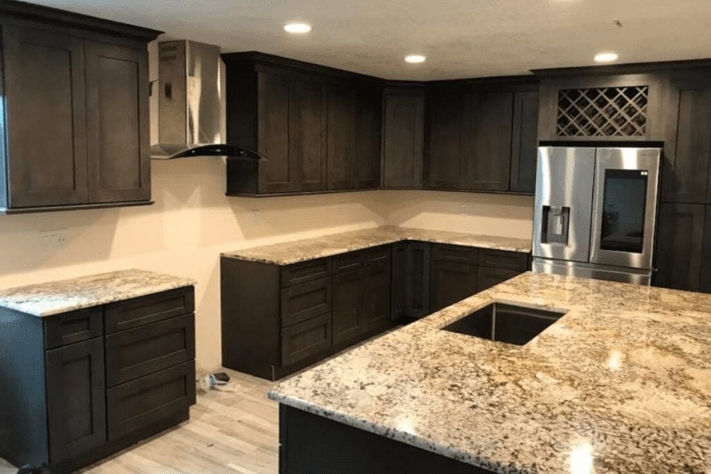 Dark espresso kitchen with granite island by 1 Stop Cabinets
