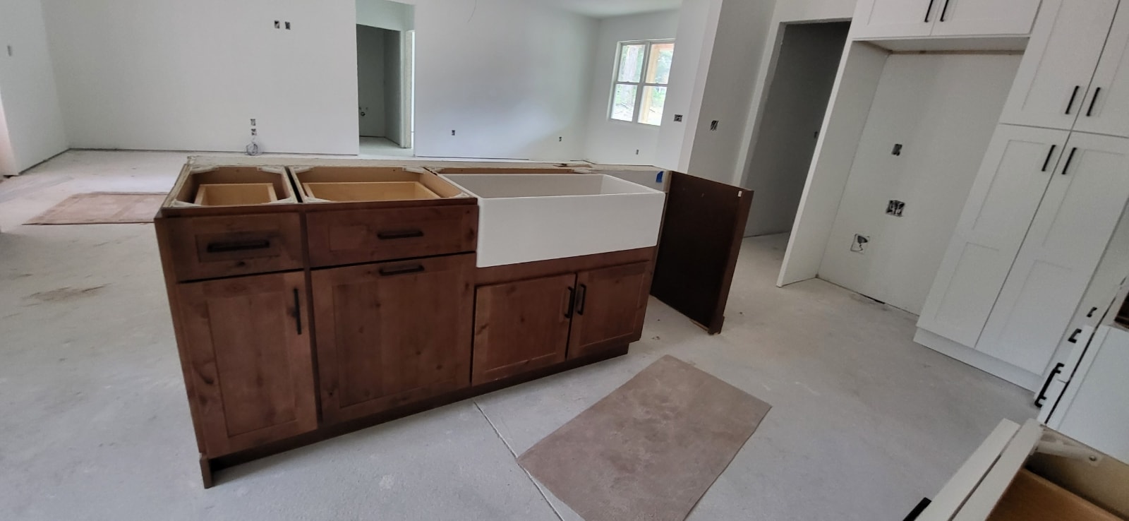 Rustic wood and white shaker new construction kitchen with farmhouse sink island by 1 Stop Cabinets